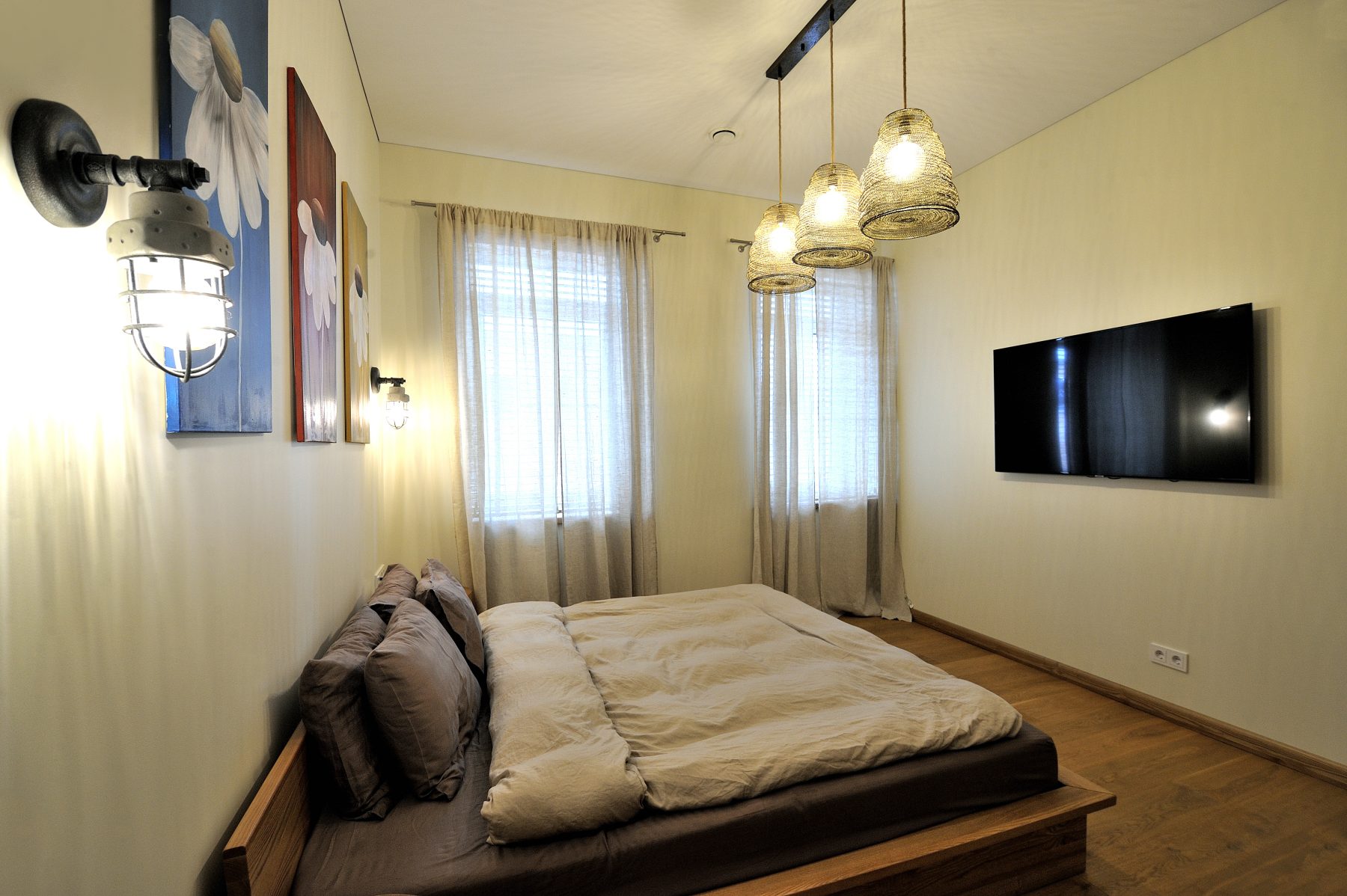 Modernus miegamojo interjeras su atvira erdve ir medinėmis grindimis